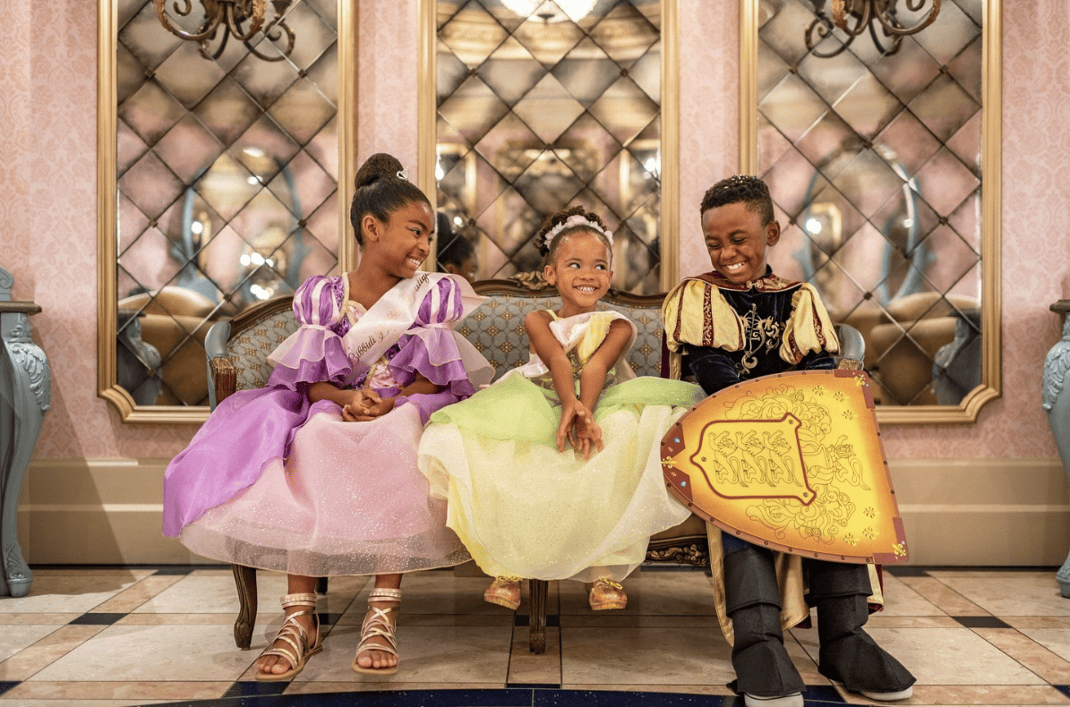 Three little kids dressed up in costumes at disneyland