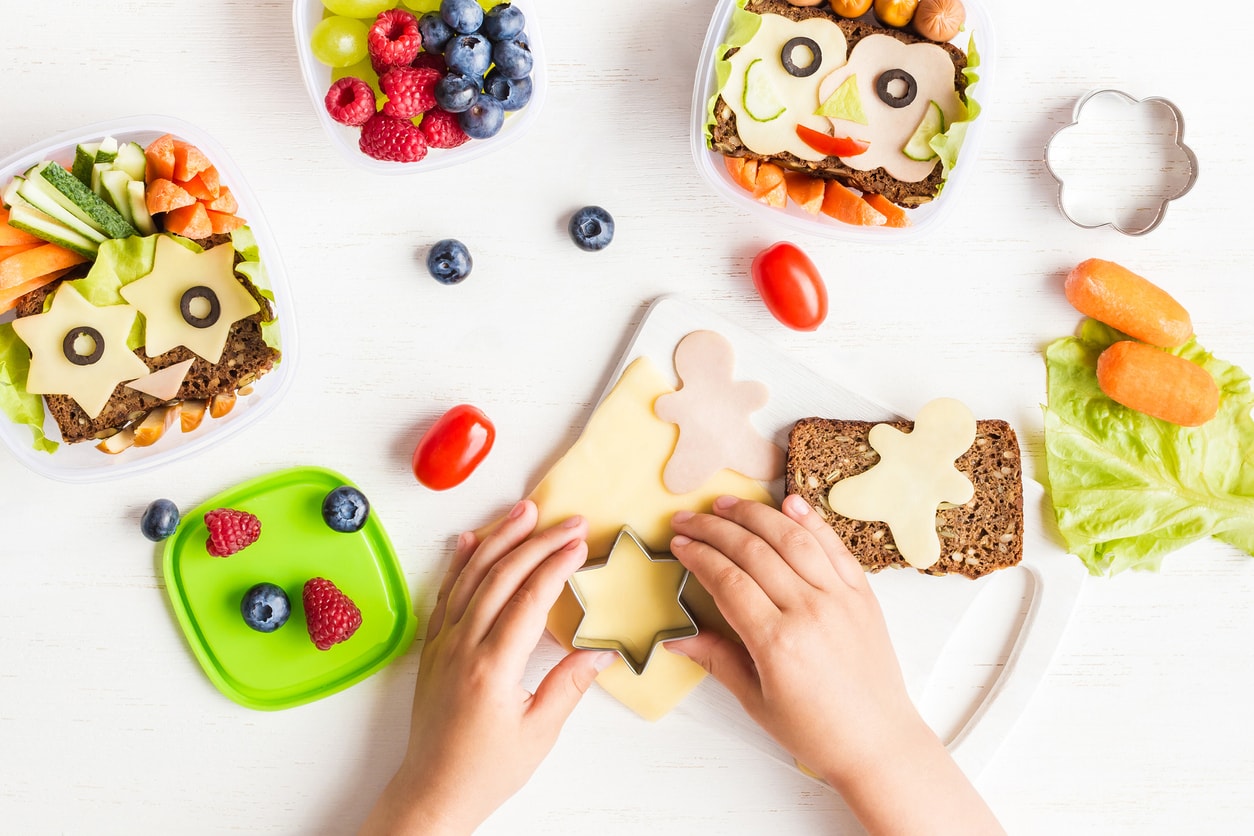 School lunch box for kids. Cooking. Child's hands. Top view, flat lay