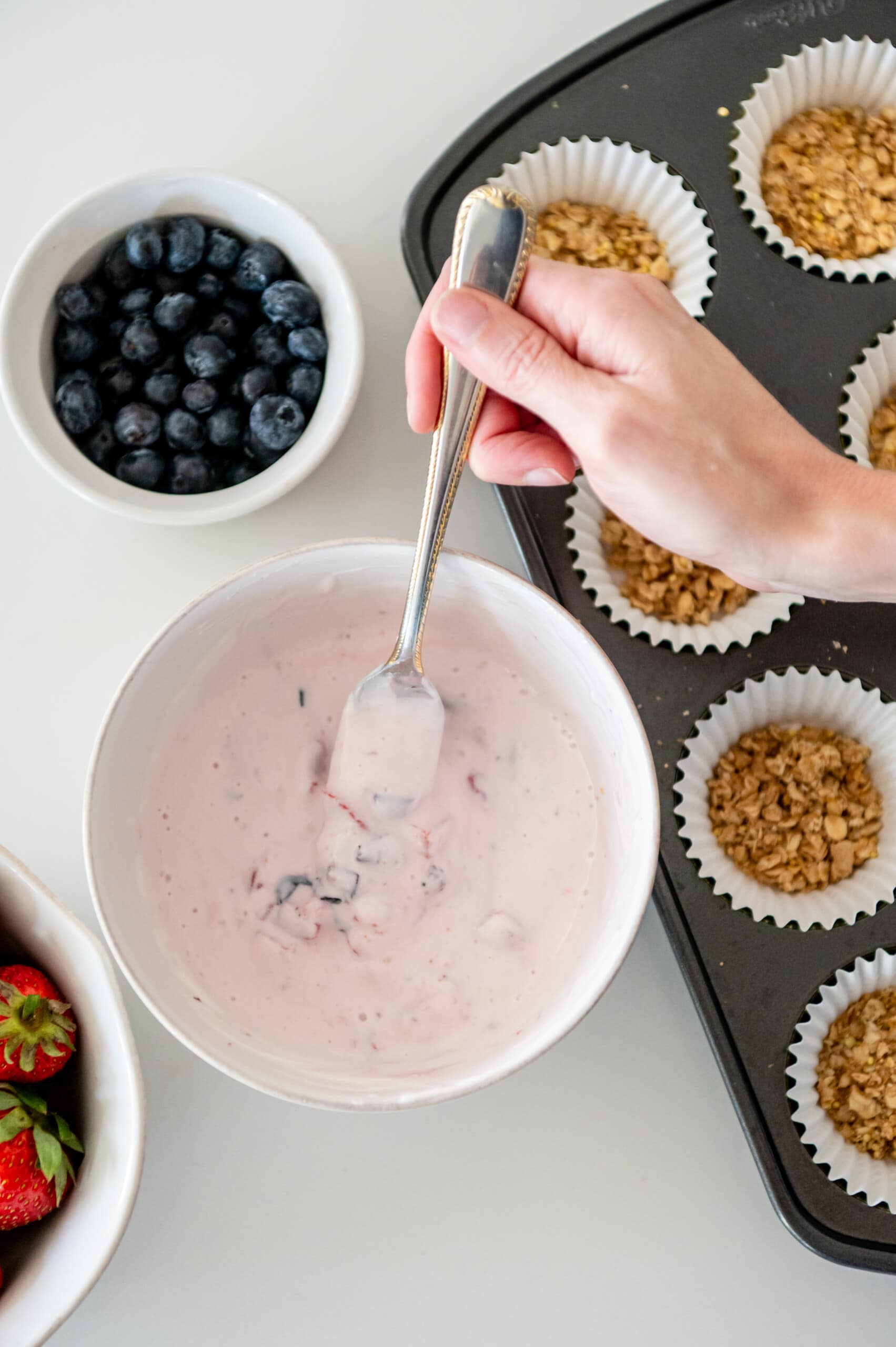 Berries mixed into a bowl of yogurt