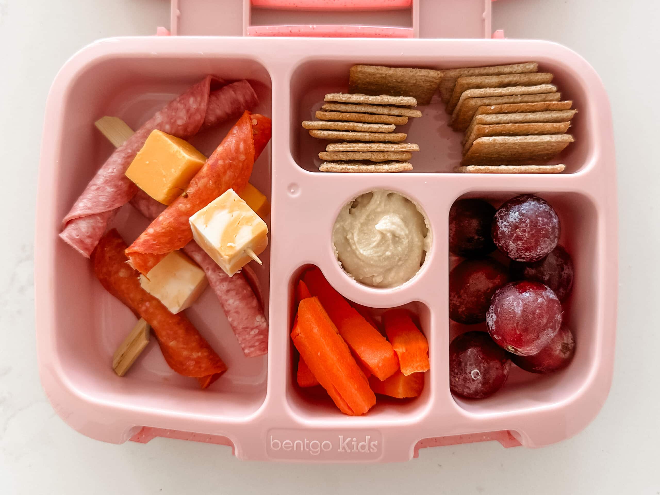 Kid's pink bento box with Charcuterie Board items