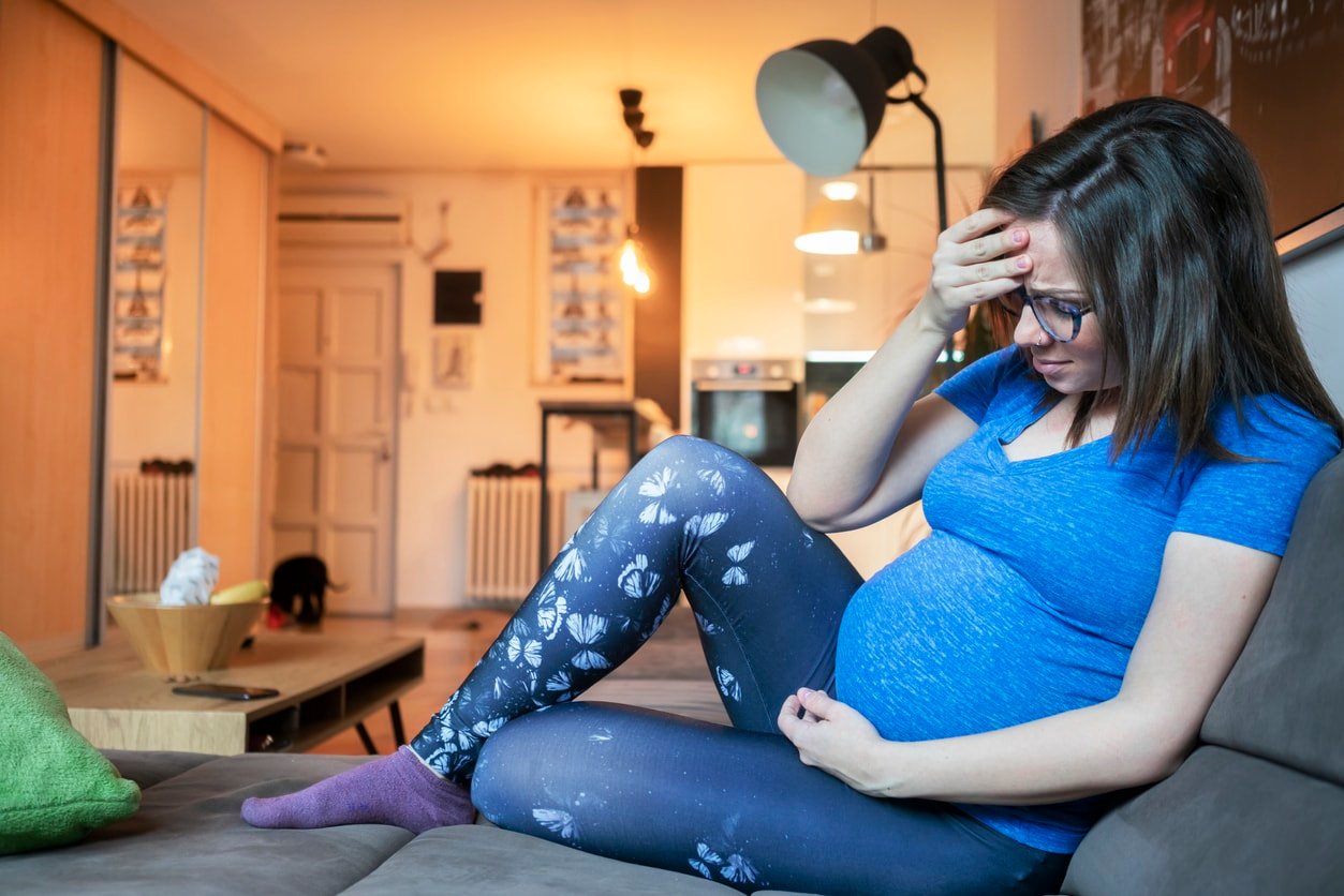 Pregnant woman at home, she is worried
