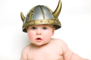 baby wearing a viking hat with a white background