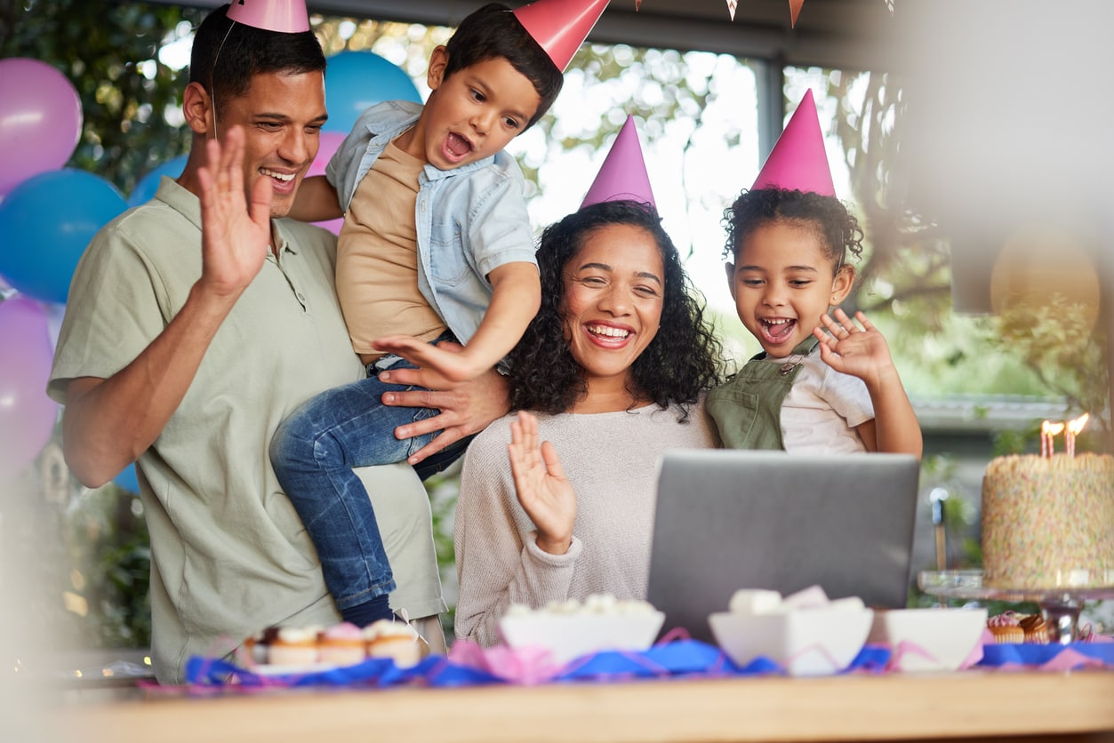 Family video call, birthday party and kids with laptop, cake or celebration for support, wave or happy in home. Child, flame and wish with contact, food and dessert with gift, hat or webinar at event