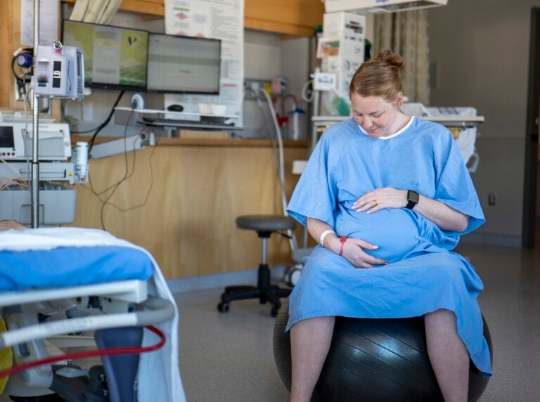 Woman in labour on a yoga ball in the hospital
