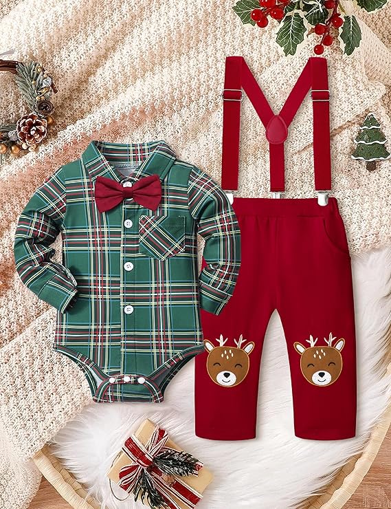 Cute Christmas outfit featuring a green plaid shirt with pocket and red bow tie, paired with red pants adorned with reindeer faces at the knees. This adorable baby boy ensemble rests on a knitted cream blanket, surrounded by festive decorations and a wrapped gift.