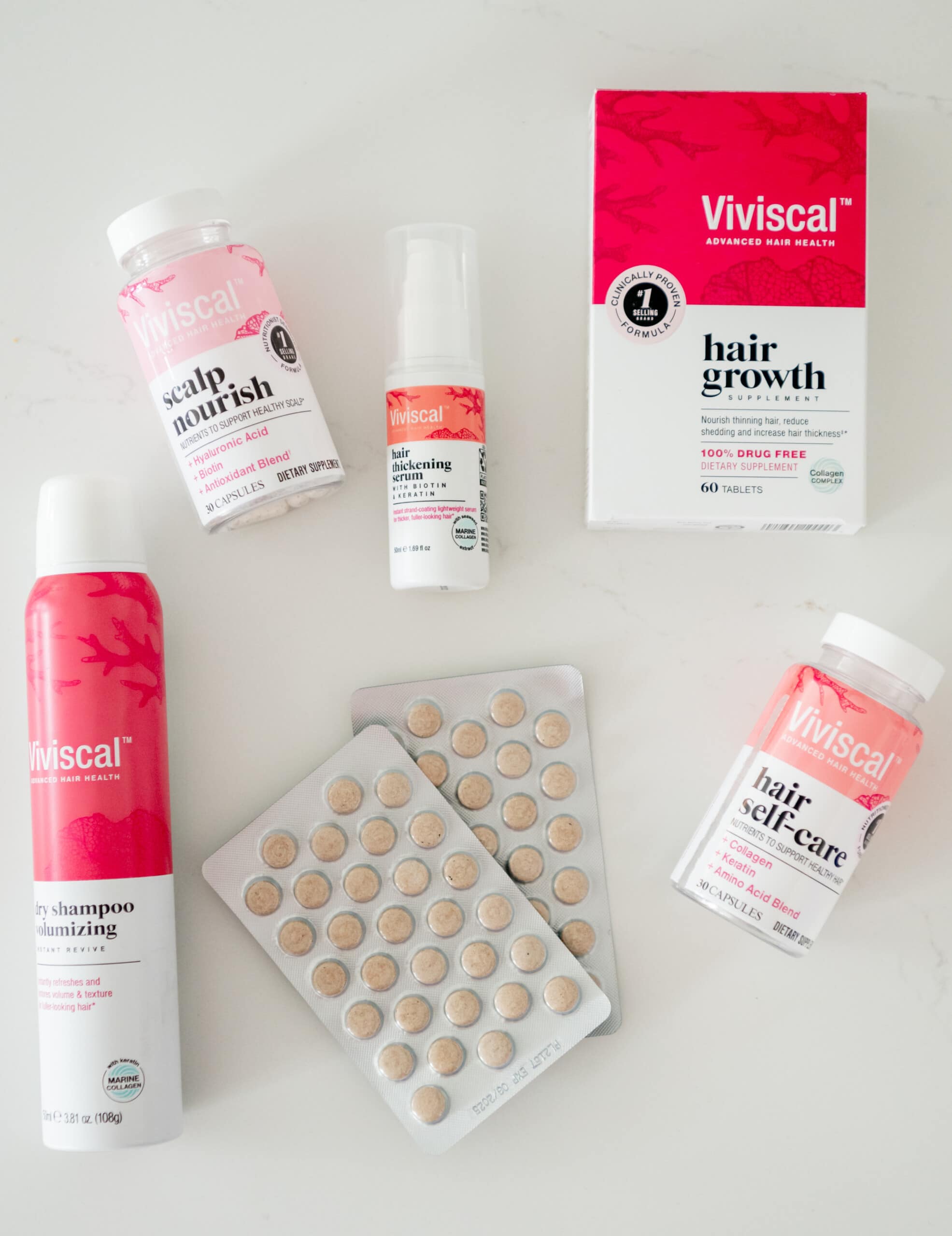 Viviscal products on a white counter. Overhead photo.