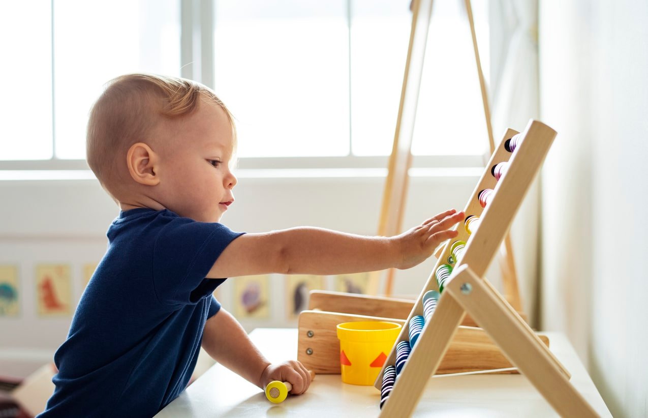 Little boy playing abacus for counting practice