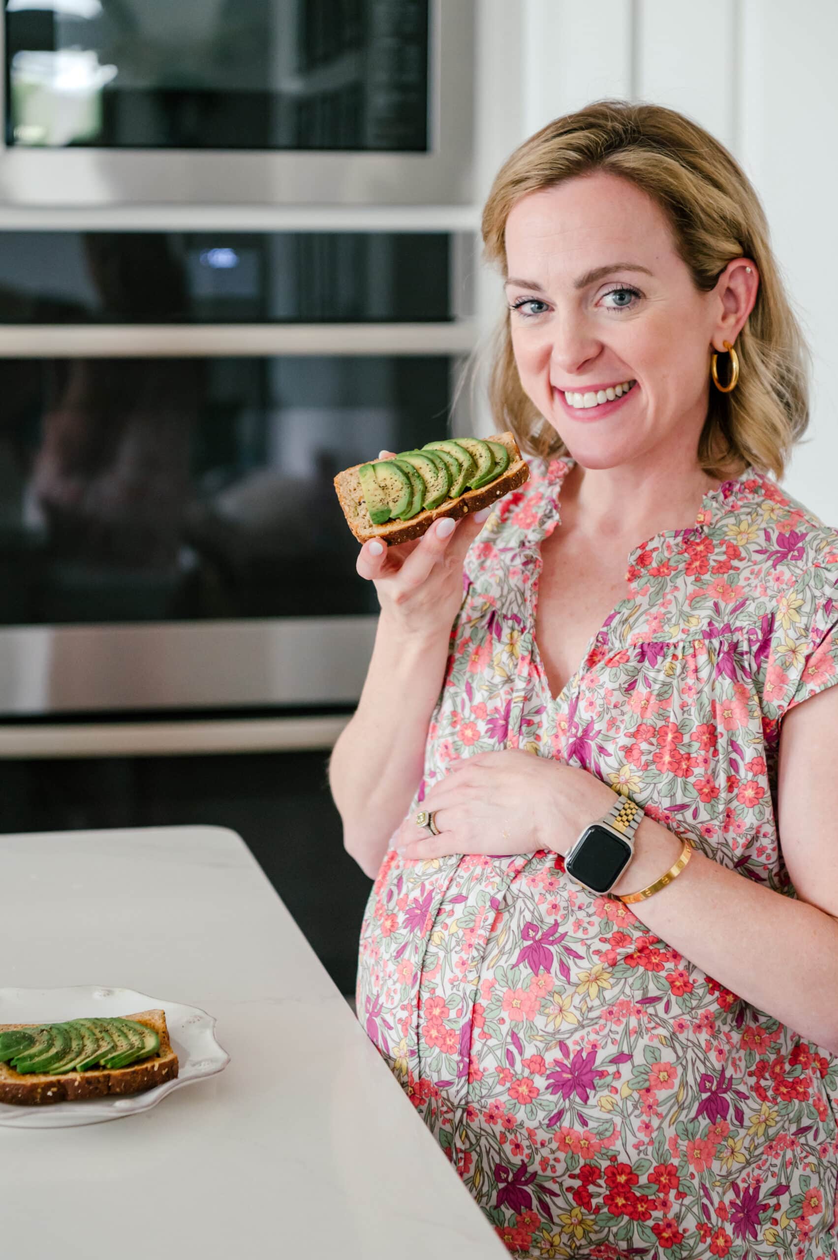Pregnant mom eating avocado toast