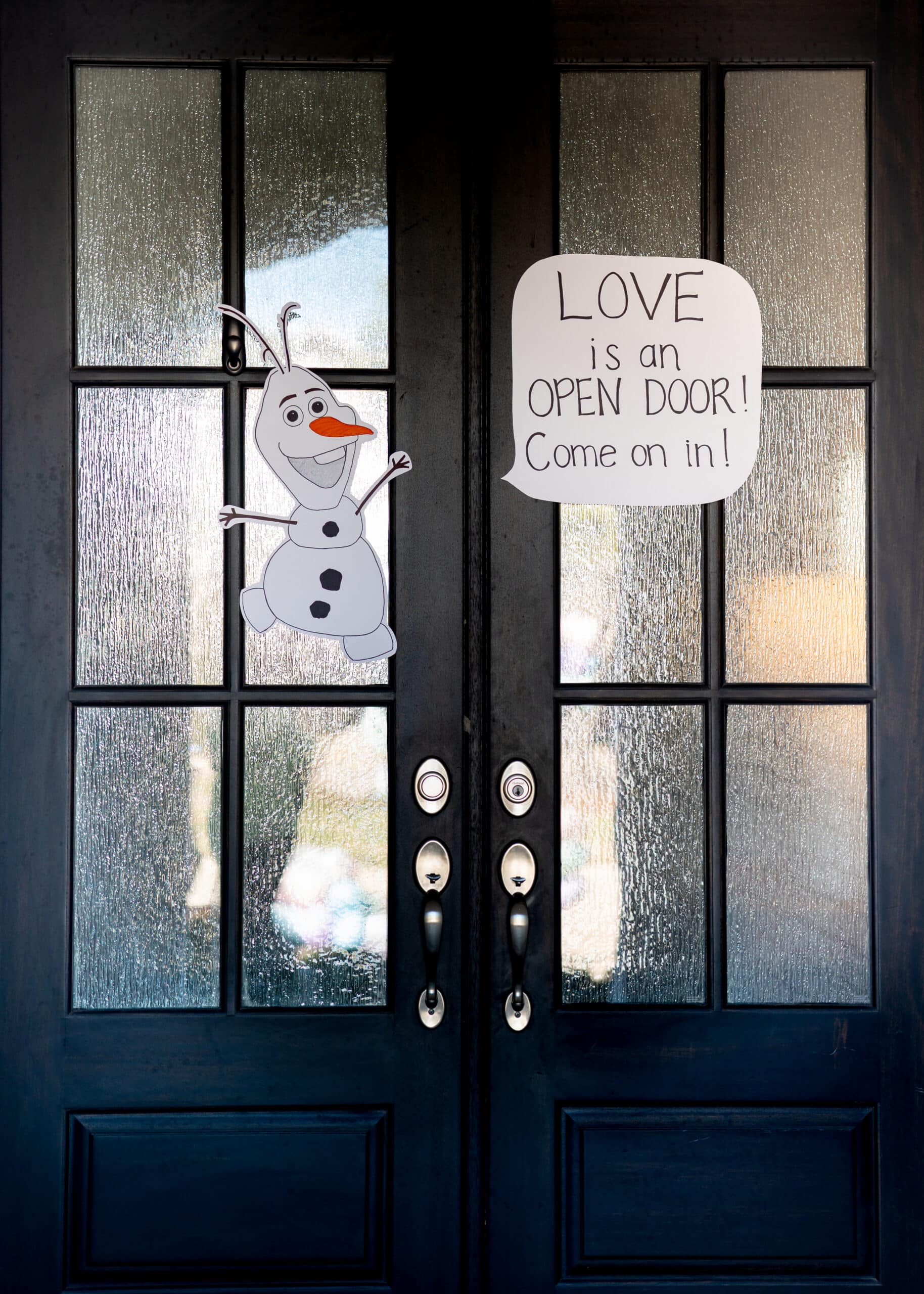 Olaf drawing on door with a sign that says Love is an open door