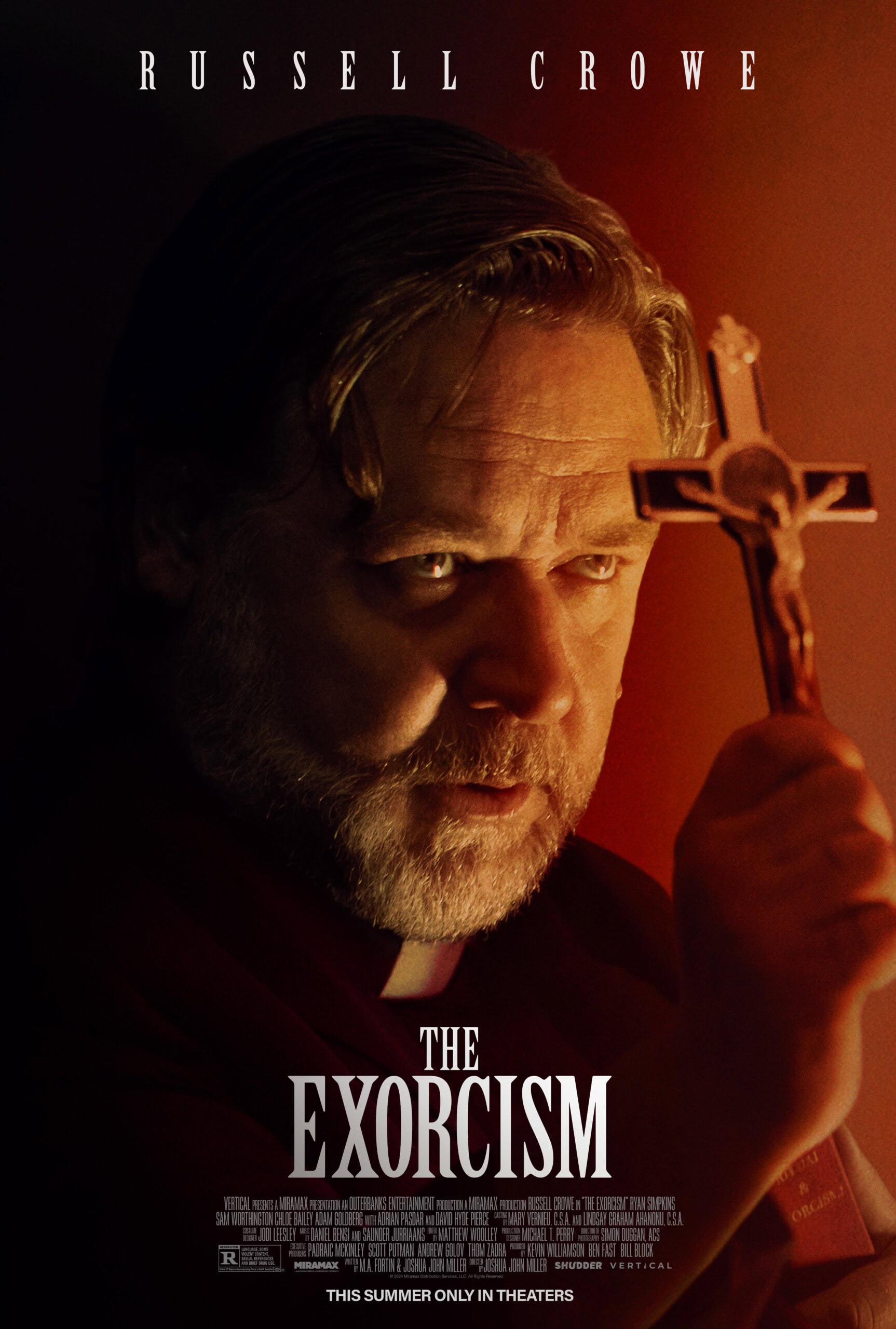 Movie poster for “The Exorcism” featuring a man holding a crucifix. He appears serious, with a focused gaze and a dimly lit background. Text at the top includes the actor's name, and the movie title is prominently displayed at the bottom with additional credits. A must-see for those deciding what to watch.