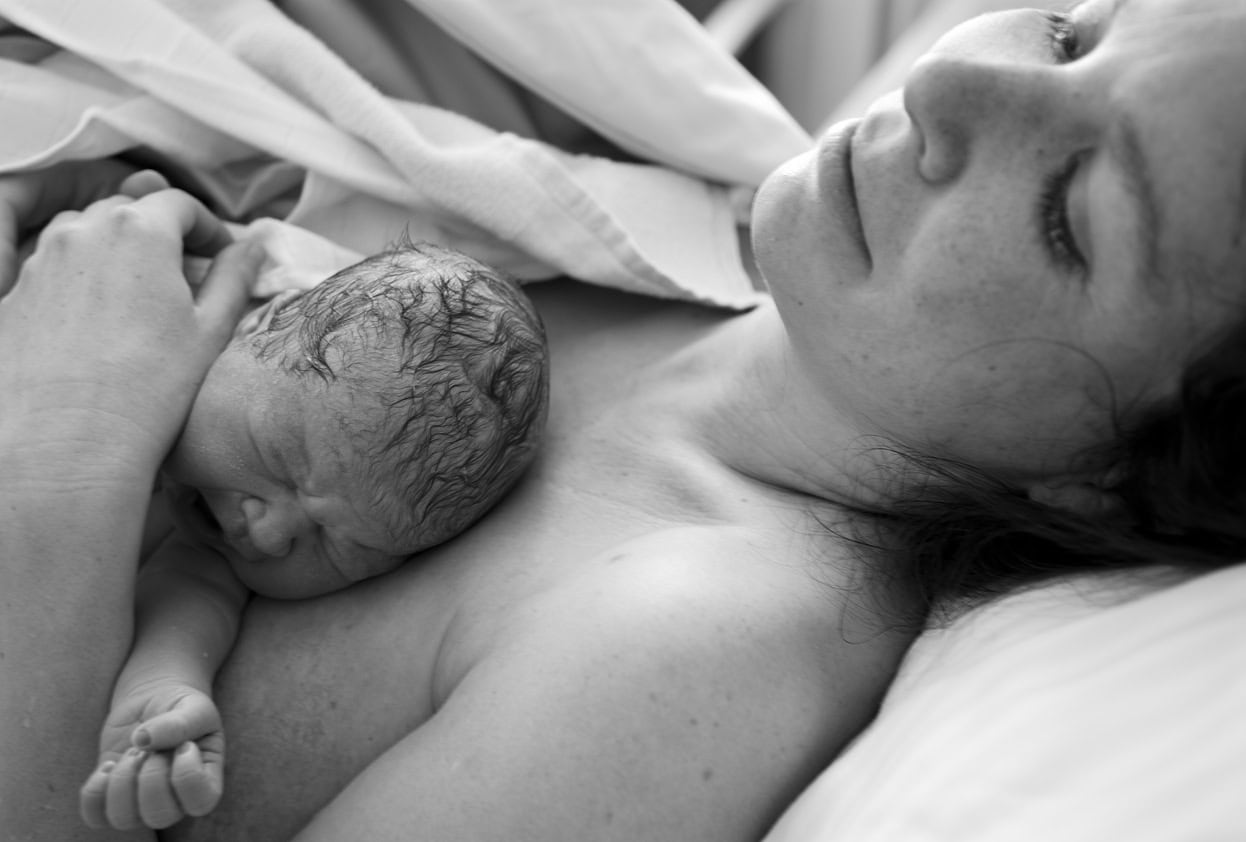 Newborn Baby Lying on Mother's chest, Black and White photo