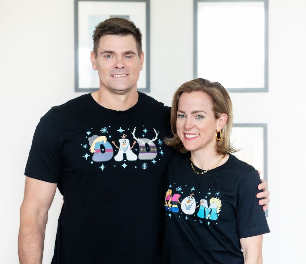 Man and woman wearing custom Frozen mom and dad t-shirts
