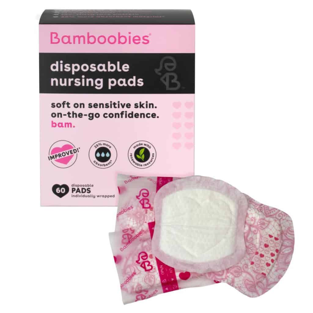 A box of Bamboobies disposable nursing pads, a key postpartum essential, is displayed alongside three individual pad packages. The black box with pink accents promotes softness on sensitive skin, on-the-go confidence, and improved design. Contains 60 individually wrapped pads for your postpartum recovery.