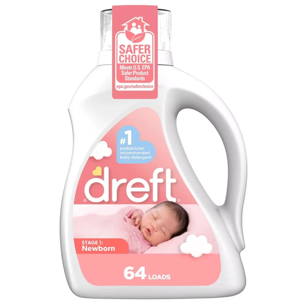 A bottle of Dreft Stage 1: Newborn baby detergent with a sleeping baby on the label. The number one pediatrician-recommended baby detergent, it provides 64 loads and is a postpartum essential. A Safer Choice label is present on the bottles neck.
