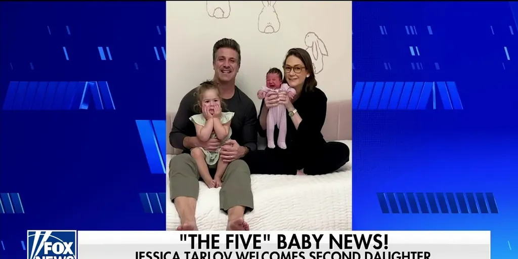Jessica Tarlov and husband pose on a couch with their two daughters. The husband is holding one child while Jessica holds the new baby, Teddie. The image is framed by a blue graphic background with the text The Five Baby News! Jessica Tarlov welcomes second daughter at the bottom.