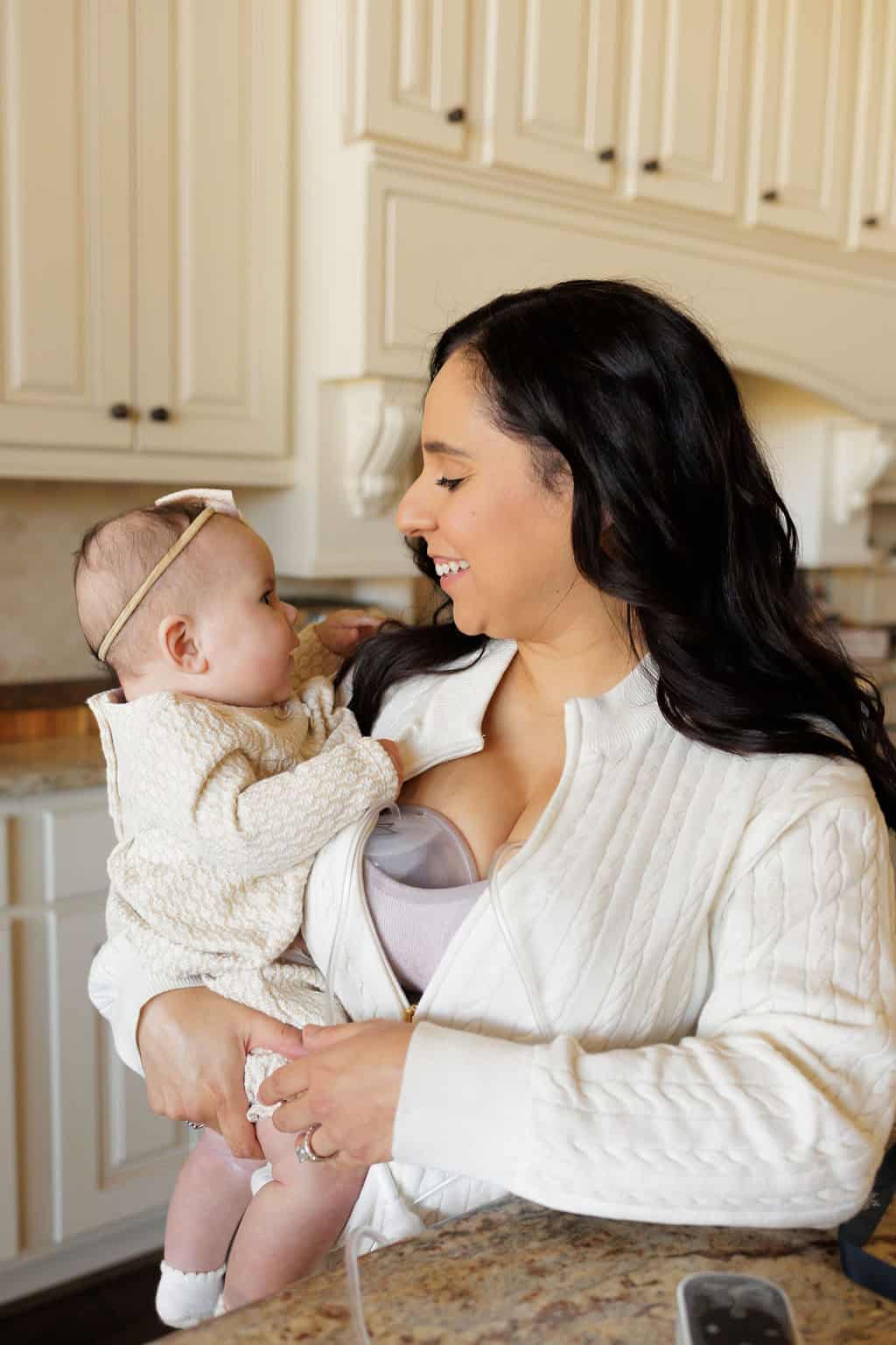 Mother breastfeeding baby with a breast pump.
