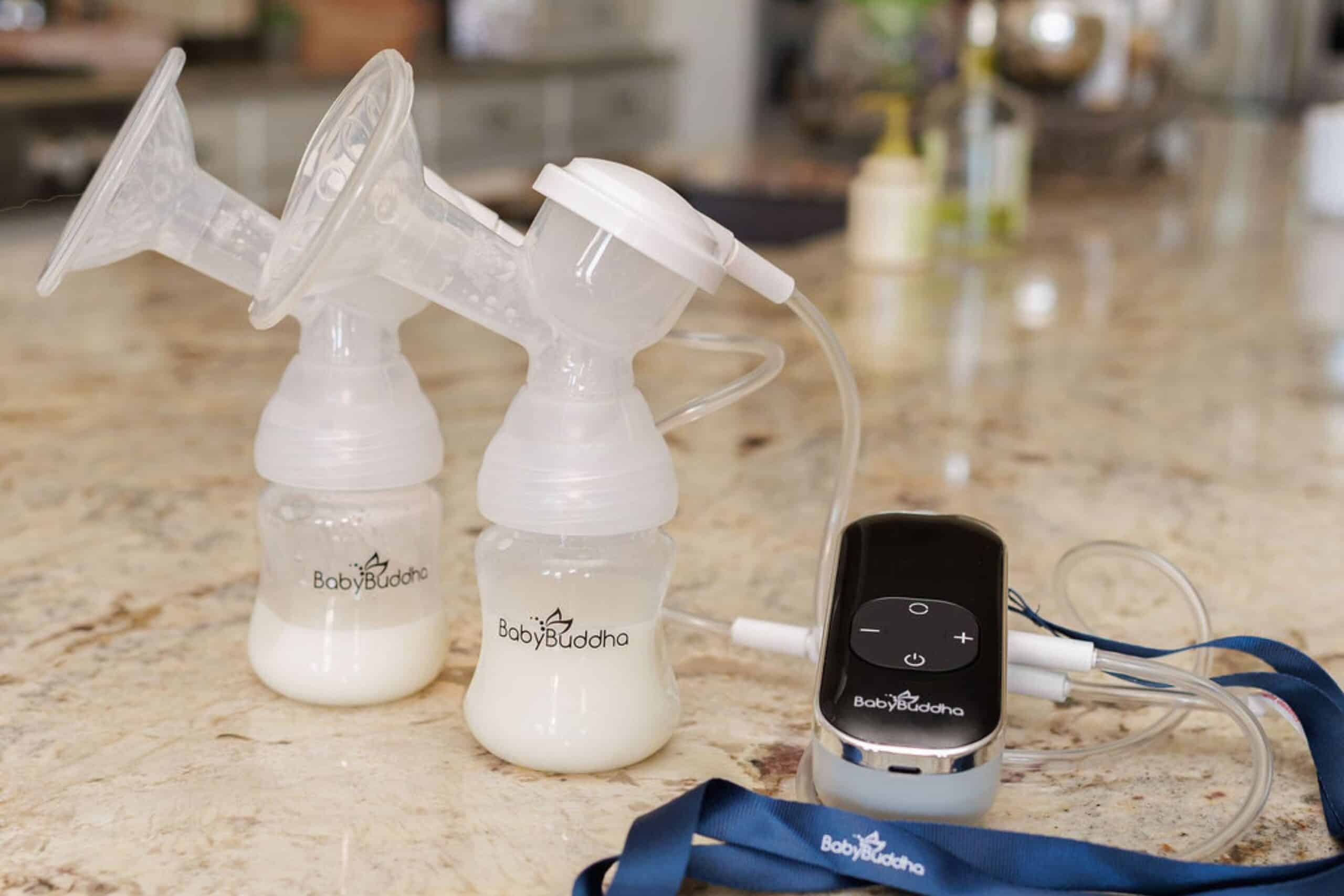 Double wearable breast pump with digital control on kitchen counter.
